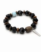 Faceted black agate bracelet with agarwood and blue larimar accent on white background