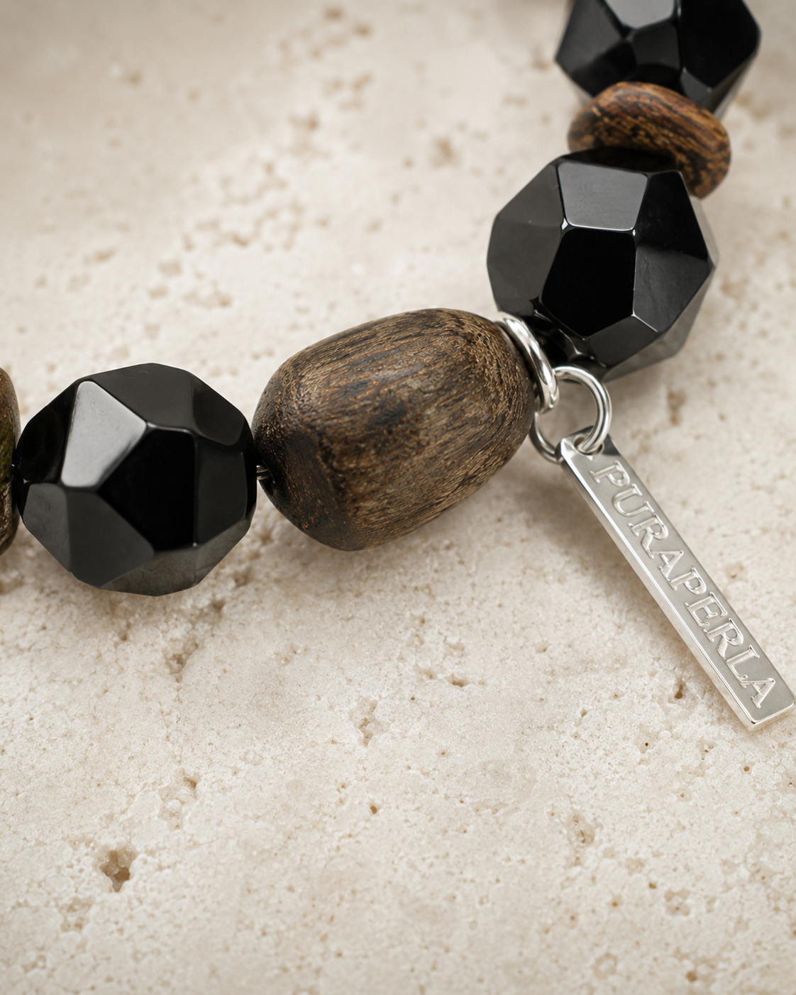 Black agate and larimar bracelet worn on an adult wrist