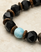 Close-up of 10 mm faceted black agate beads and wood spacer beads